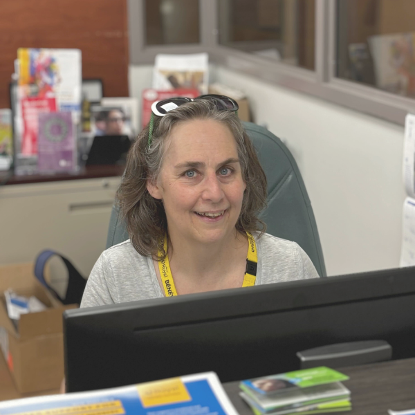 Christine sitting at front desk in the Hub