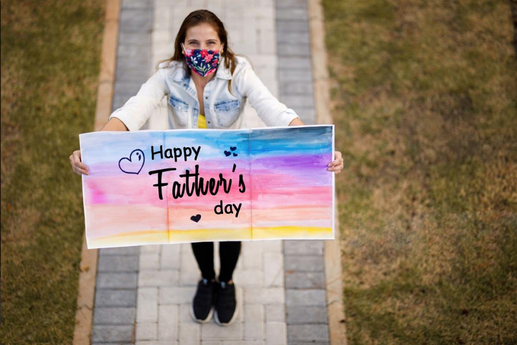 Woman holding 'Happy Father's Day' sign