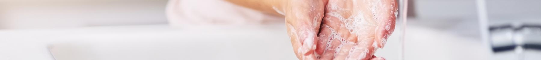 Woman washing hands in sink