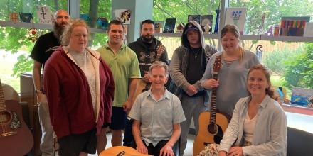 Ottawa musician Michael Fahey (centre) and recreation therapist Ashleigh McGuinty (seated at right) with some members of The Royal’s guitar group.